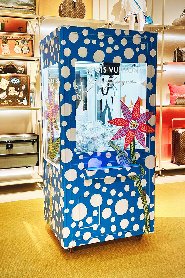 Louis Vuitton branded claw machine at an event activation