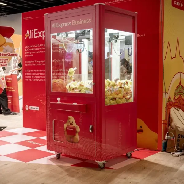 AliExpress branded claw machine at a business trade show booth