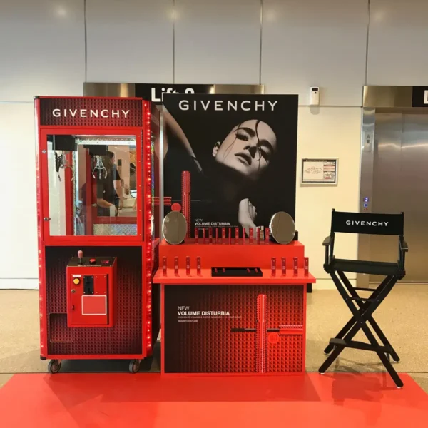 Givenchy branded claw machine set up alongside a retail product display