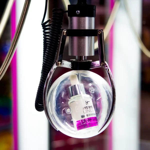 Claw gripping a clear prize ball containing an IT Cosmetics product