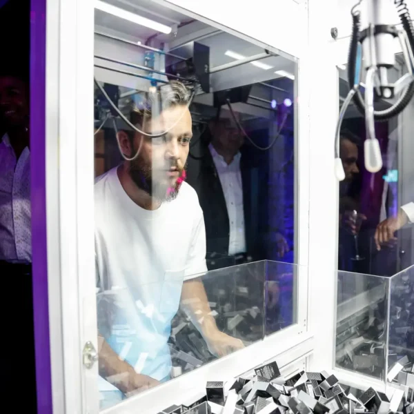 Guest concentrating while playing a Jimmy Choo branded claw machine