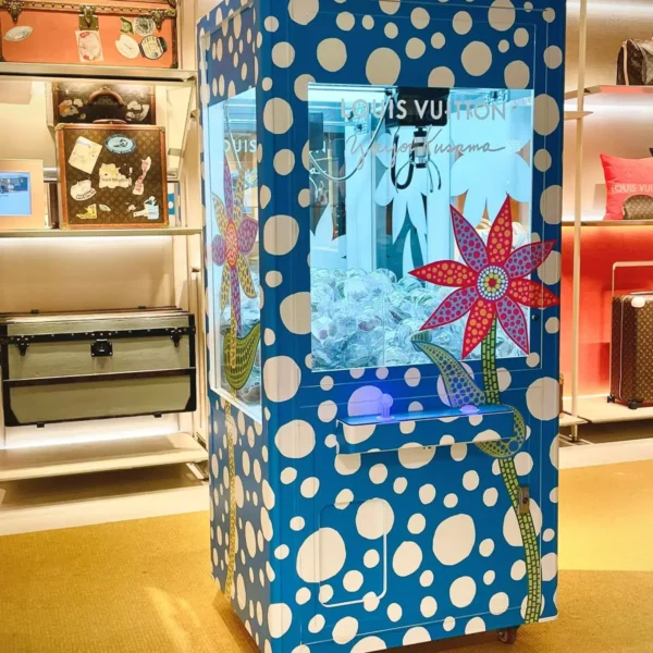 Louis Vuitton branded claw machine installed inside a retail store