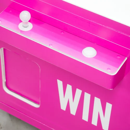 Close up of a claw machine control panel with WIN branding