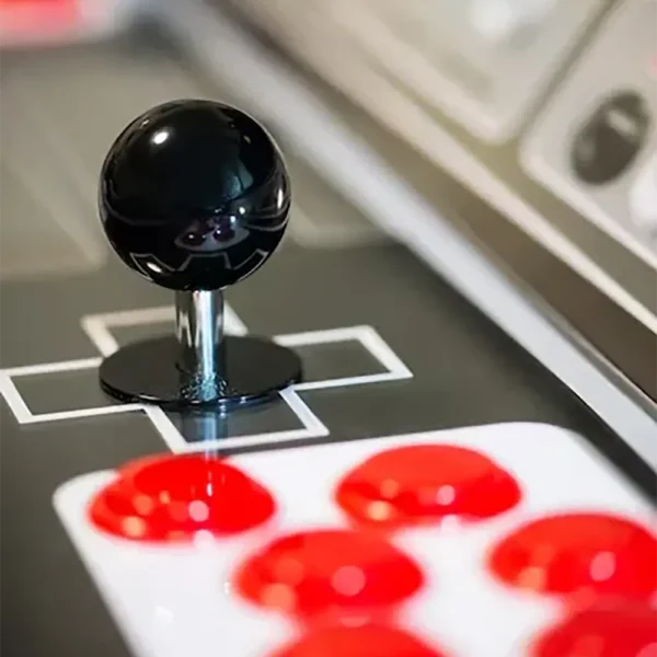 Close up of arcade machine joystick and illuminated action buttons