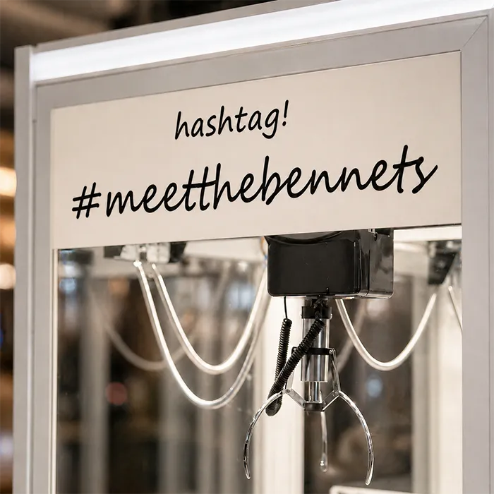 Custom wedding claw machine header sign with #meetthebennets branding.