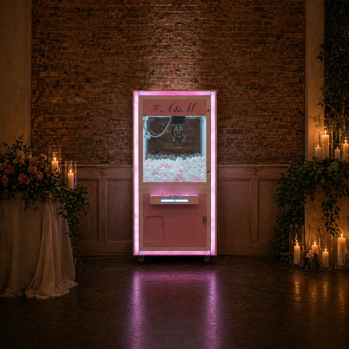 Pink claw machine hire setup for wedding reception