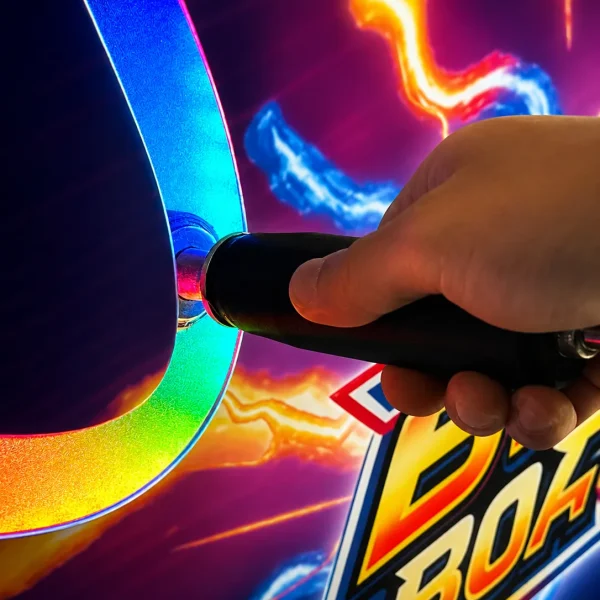 Close-up of a hand using a Buzz Board wand on a colorful electric-themed game panel.