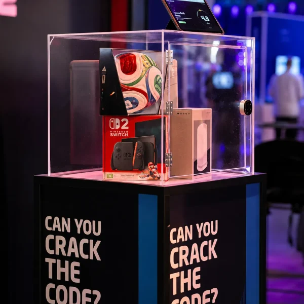 Close-up of Mimecast prize safe with acrylic lock box, prizes inside and “Can You Crack the Code?” branded plinth.