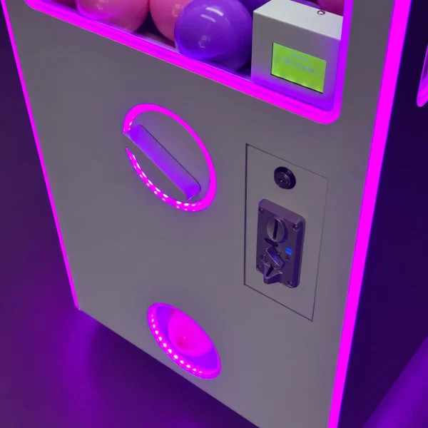Close-up of a capsule vending machine with purple LED lighting and capsules