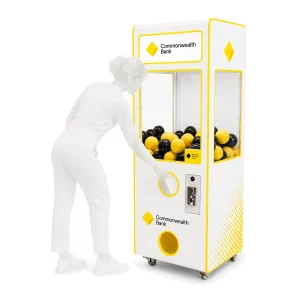 Commonwealth Bank branded capsule vending machine with yellow and black capsules